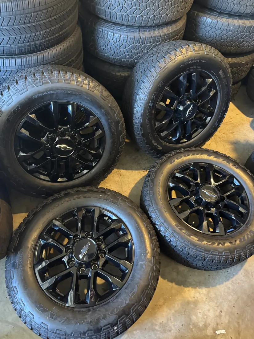 Dfw Takeoffs black Chevrolet factory wheels with all-terrain tires